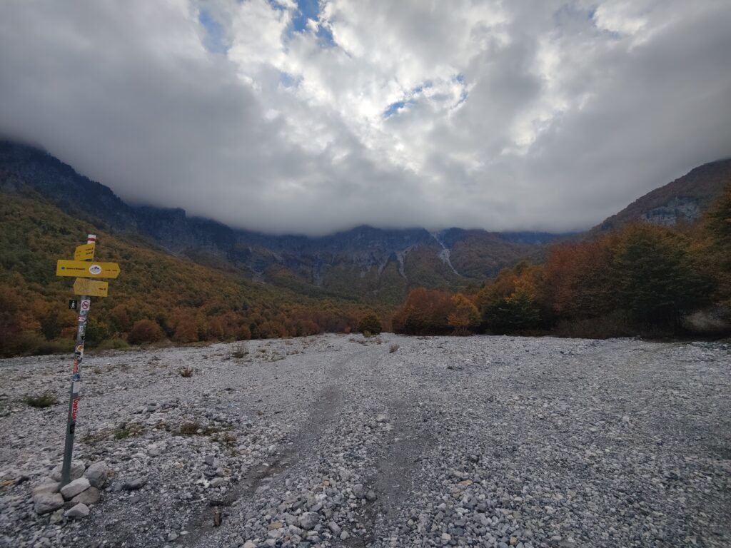 Rocky area with a mountain range in the background, Valbona river basin
